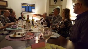 Dinner party with people conversing around table.